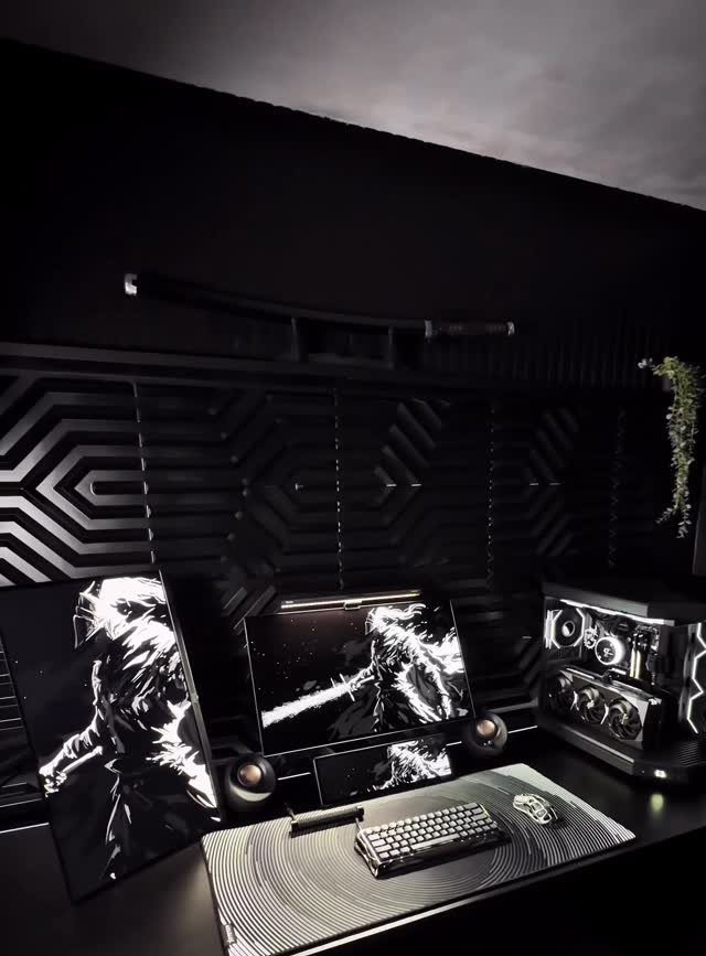 All black gaming setup with geometric wall panels and high contrast monochrome monitors.