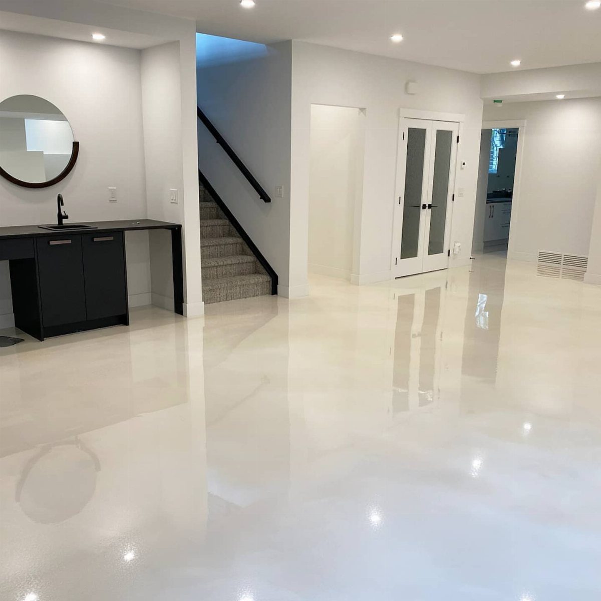 10 Basement Wall Paint Ideas to Refresh Your Space 3 Bright white walls and glossy white floors in a modern interior room.