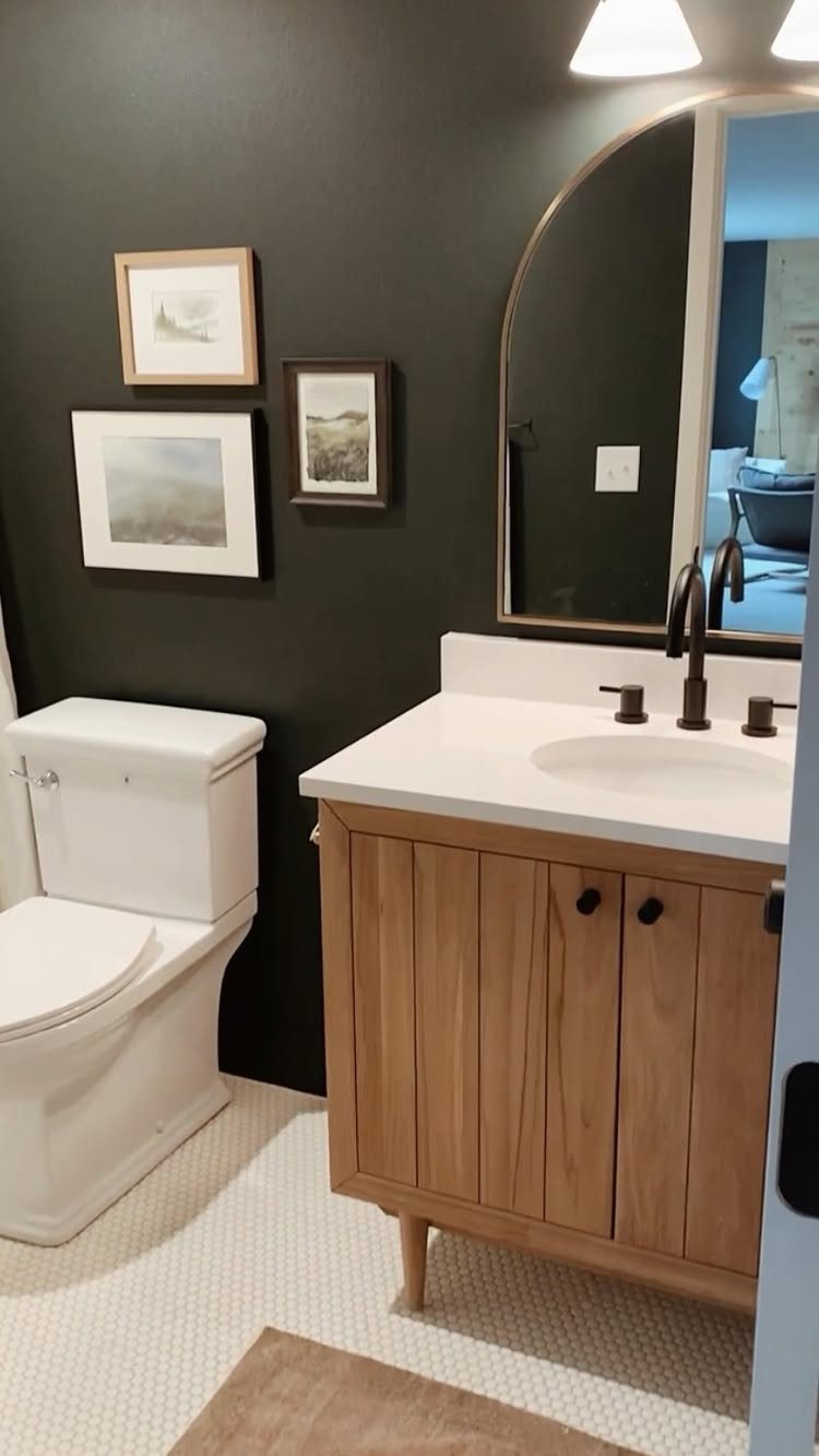 10 Basement Wall Paint Ideas to Refresh Your Space 4 Dark charcoal gray bathroom walls with a light wood vanity and white toilet.