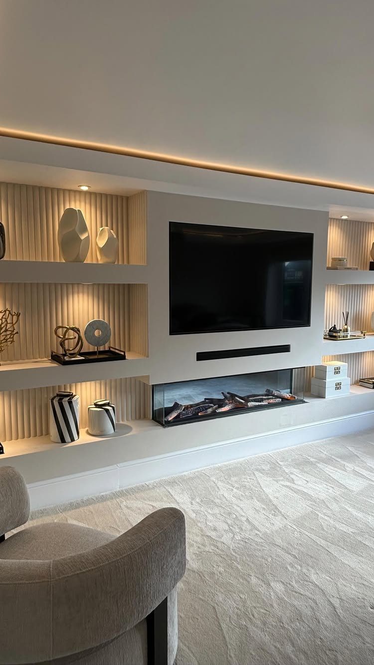 Light grey textured carpet in a modern media room with a television and fireplace.