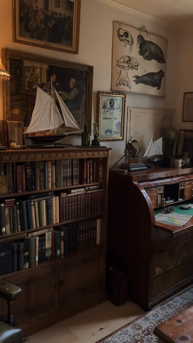 Vintage study with a dark wood bookcase, roll-top desk, and model sailboat.