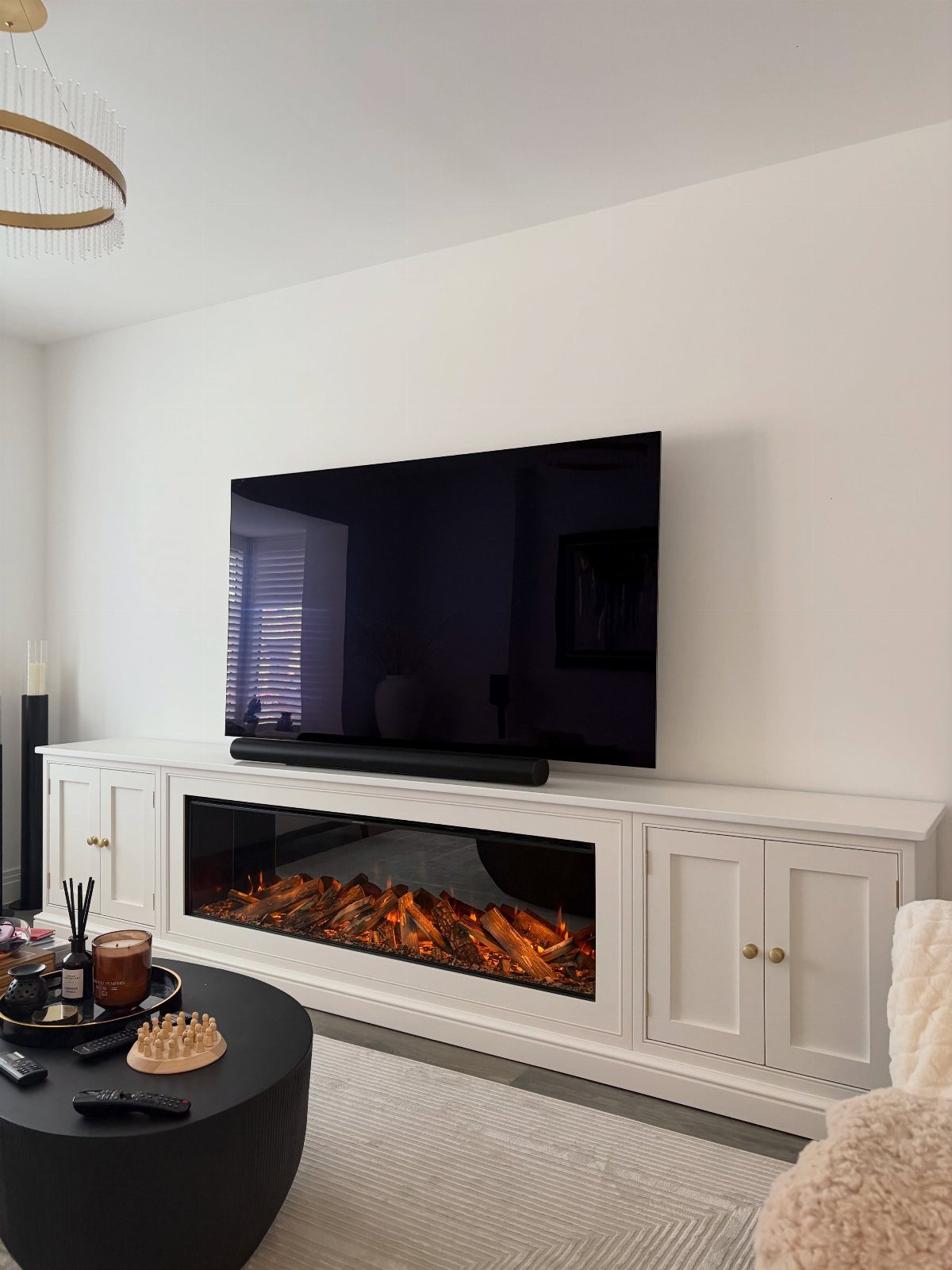 7 Family TV Room Ideas for a Comfortable Space 7 Flat-screen TV mounted on a white wall above a modern linear electric fireplace.