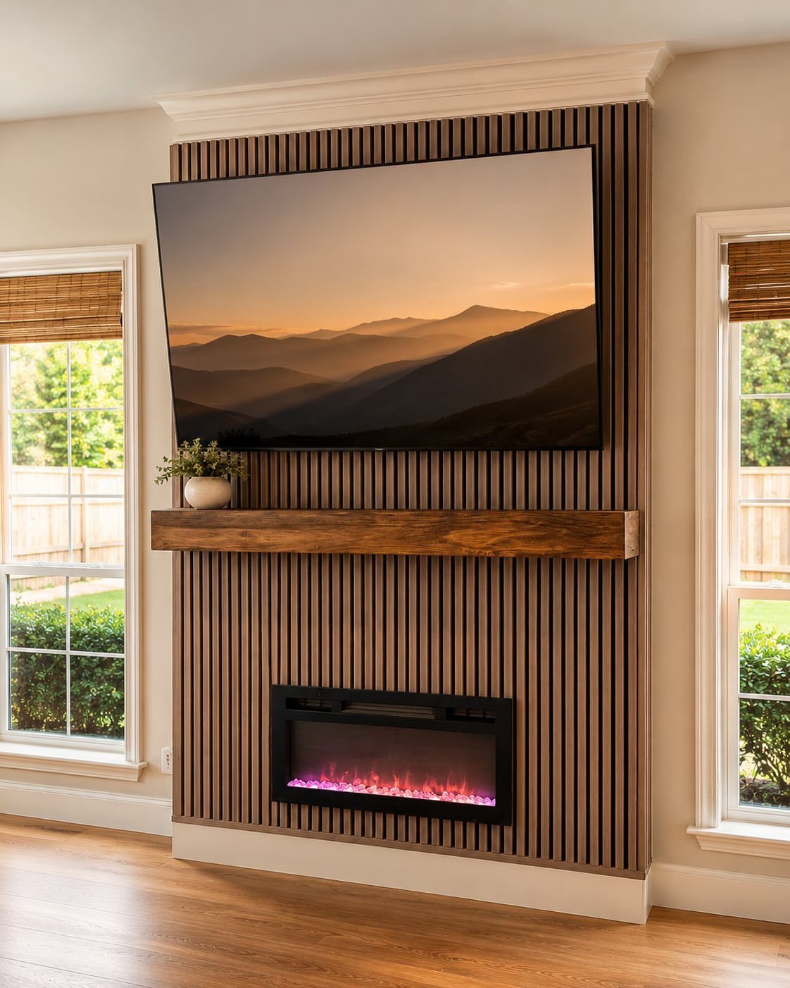 Floating wooden mantel shelf between a wall-mounted TV and a linear electric fireplace.