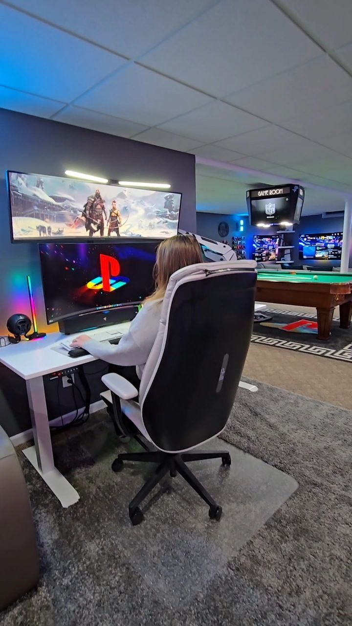 Gaming setup with a person in a chair, monitor, and pool table background.