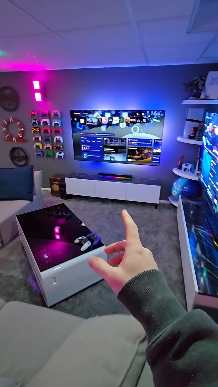 Modern adult game room with LED lighting, large TV, and controller wall display.