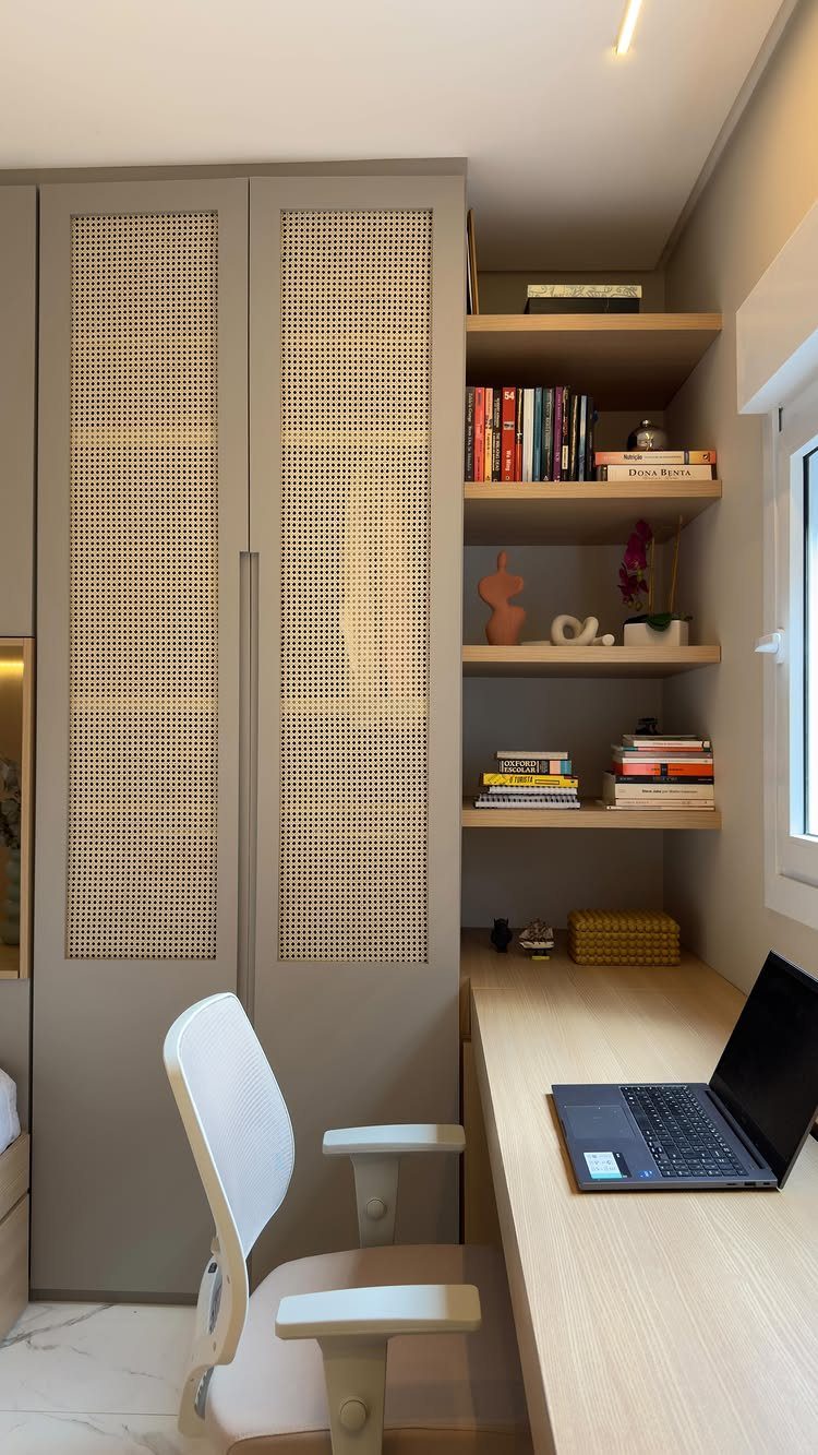 Home office with built-in cane cabinets, open wooden shelves, and a light wood desk.