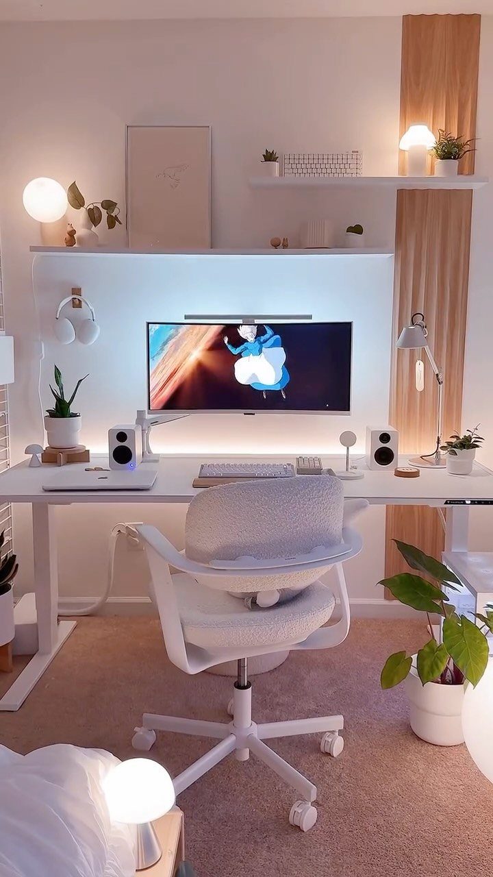 White minimalist home office with a clean desk, ergonomic chair, and soft lighting.