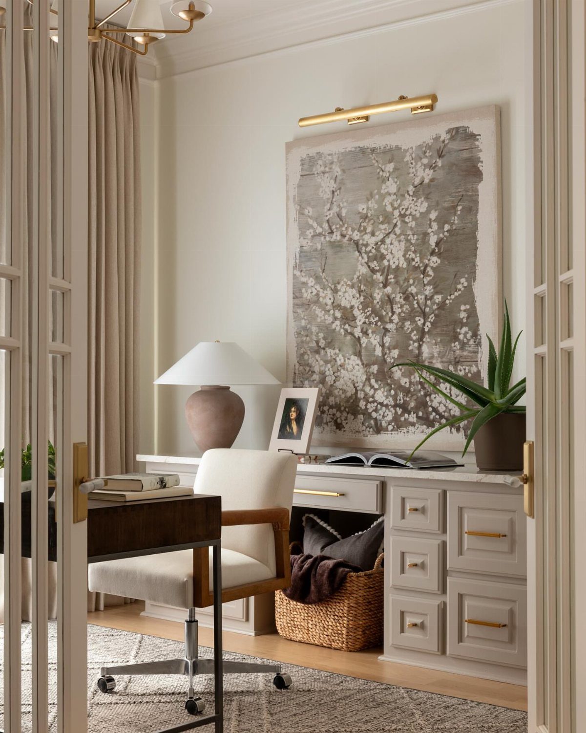 10 Home Office Paint Colors for a Productive Space 6 Beige home office with white desk, white chair, and large floral artwork.