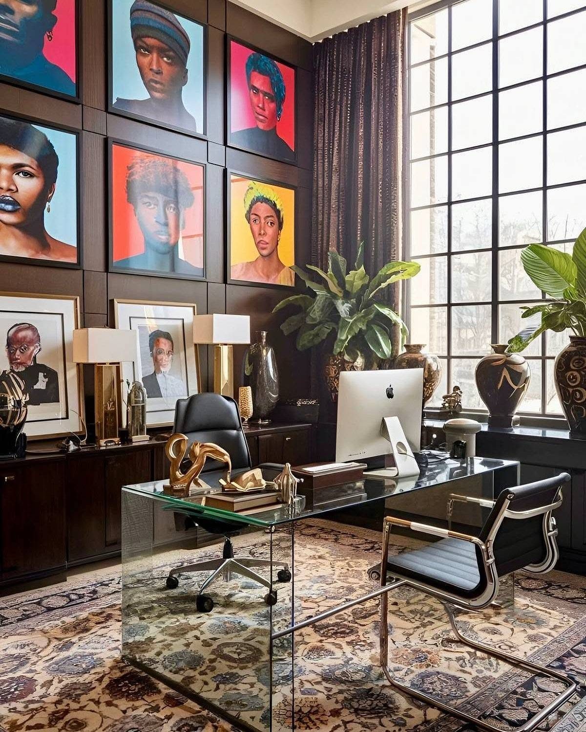 10 Home Office Paint Colors for a Productive Space 10 Home office with glass desk and dark brown paneled wall featuring colorful portraits.