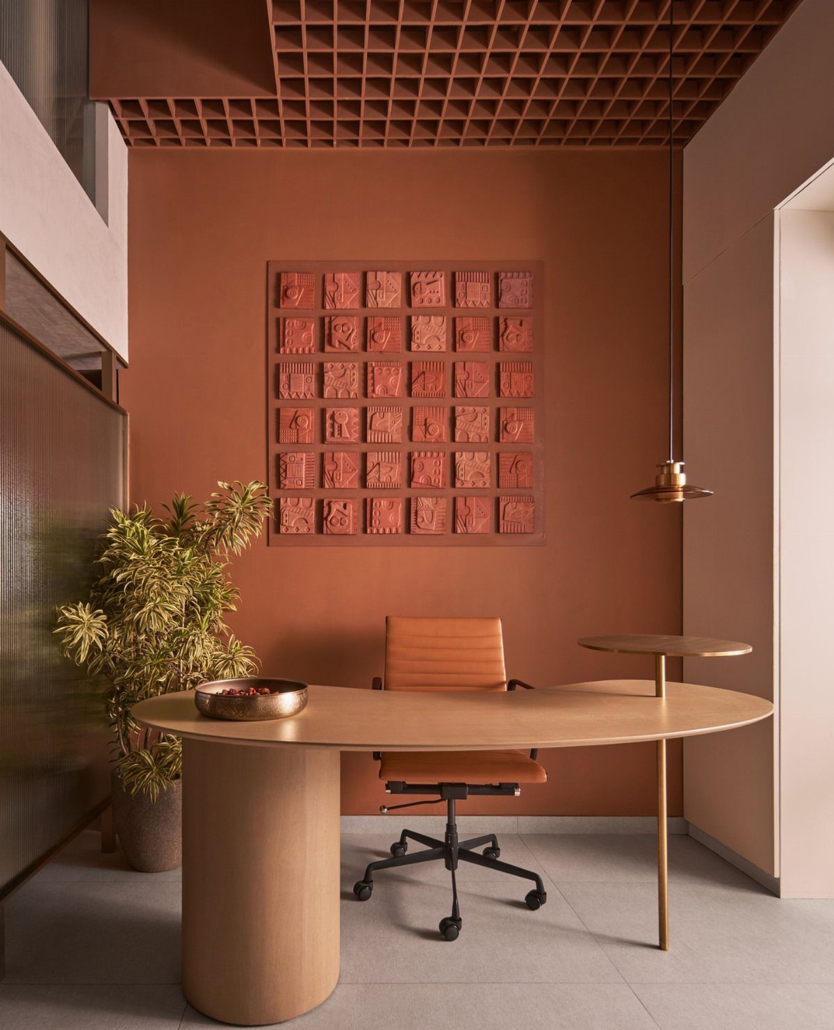 10 Home Office Paint Colors for a Productive Space 5 Terracotta painted home office with a light wood desk and tan leather chair.