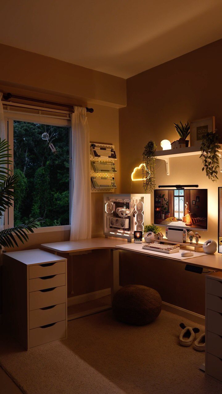 L-shaped corner desk in a warm room with a monitor and plants
