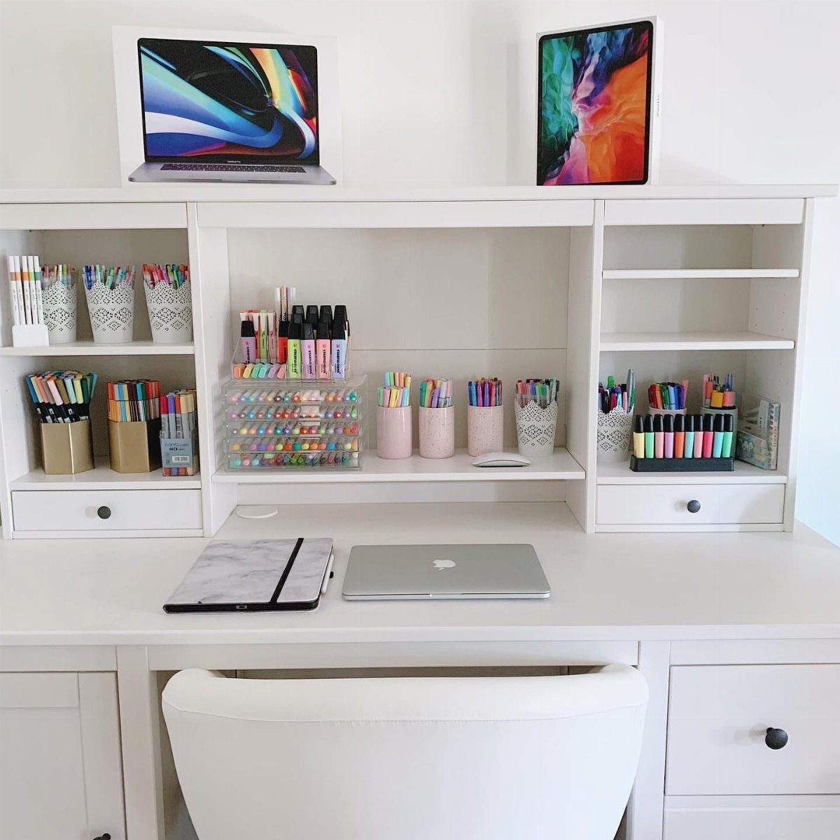 White home office desk and hutch organized with colorful art supplies and electronics.
