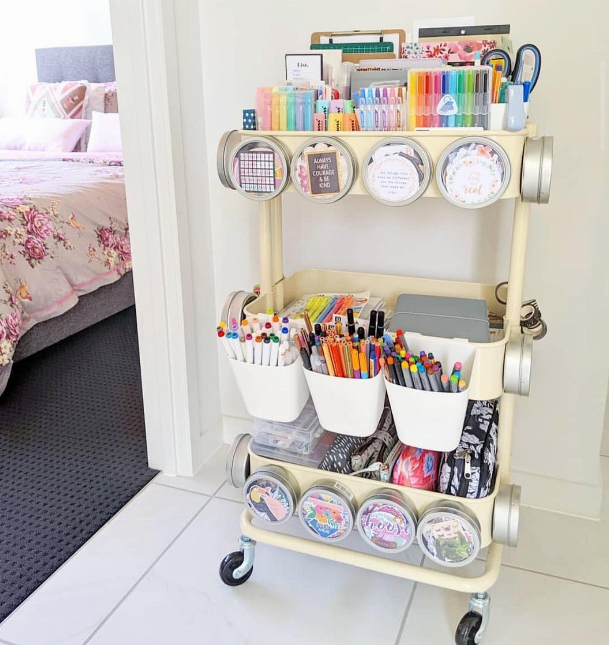 Cream rolling utility cart organized with colorful art supplies and storage containers.