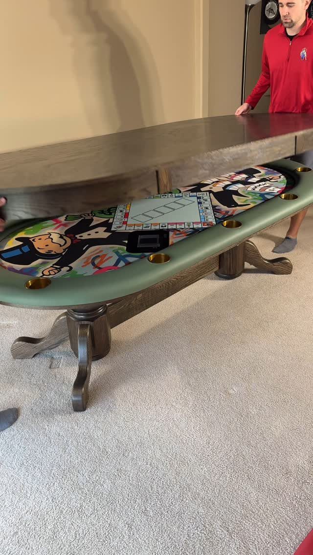 Wooden convertible table revealing a green gaming surface with a board game and cup holders.