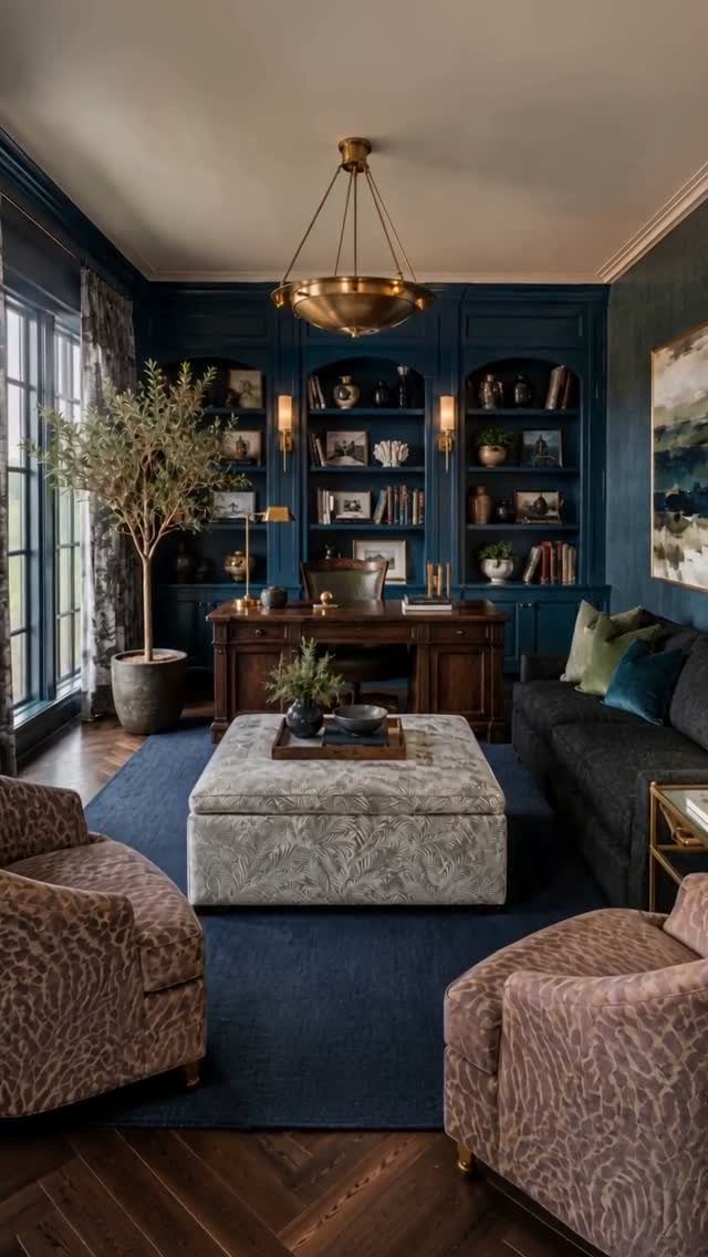 Luxury home office featuring a navy blue rug, curtains, and dark blue walls.