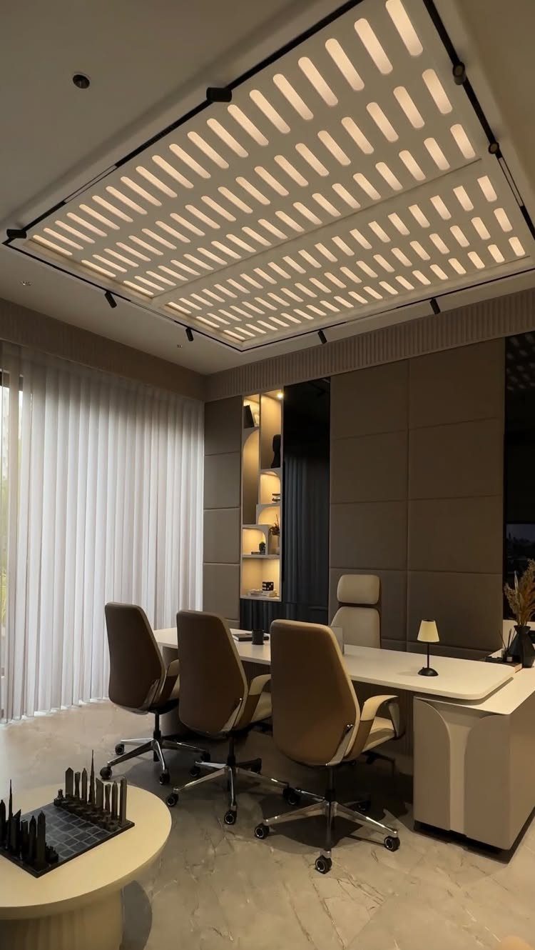 Modern luxury home office with tan leather chairs and a glowing grid ceiling.