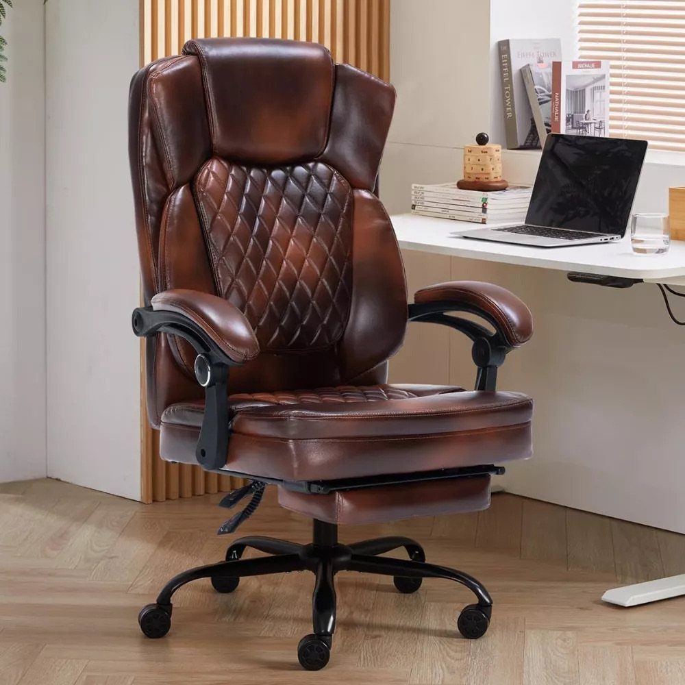 Brown leather executive office chair with footrest next to a white modern desk.