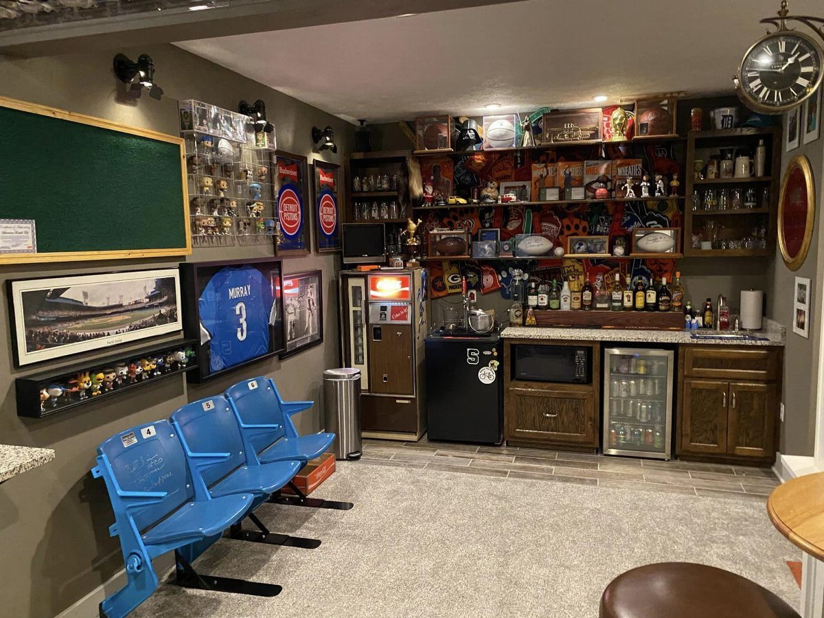 Wet bar and vending machine area in a sports themed man cave basement