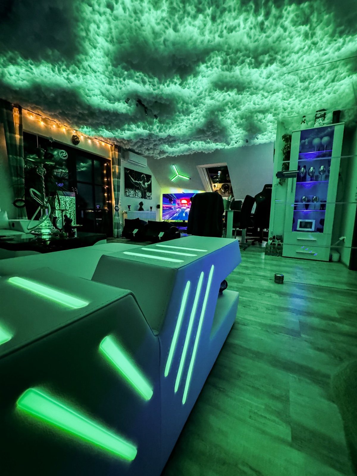 11 Man Cave Must Haves for Your Space 10 Gaming room with green LED lighting on the desk and textured ceiling.