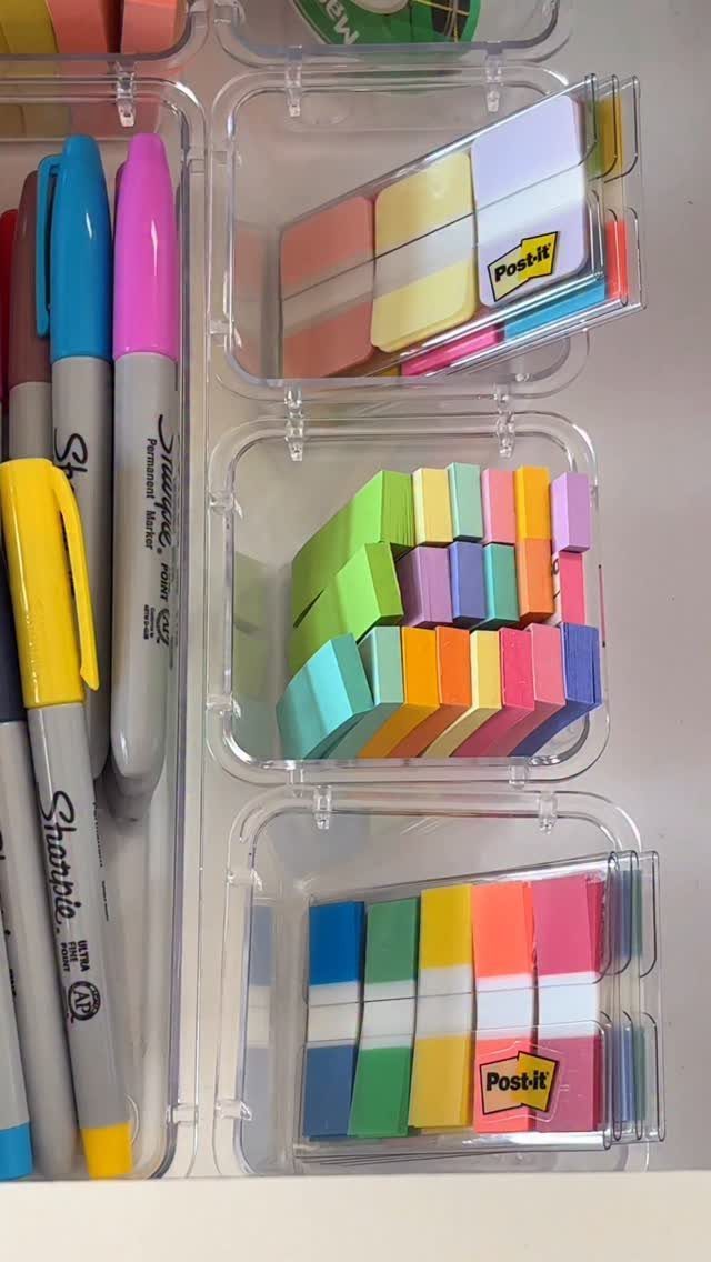 14 Office Decorating Ideas for Work to Refresh Your Space 7 Colorful markers and sticky notes organized in clear plastic storage containers.