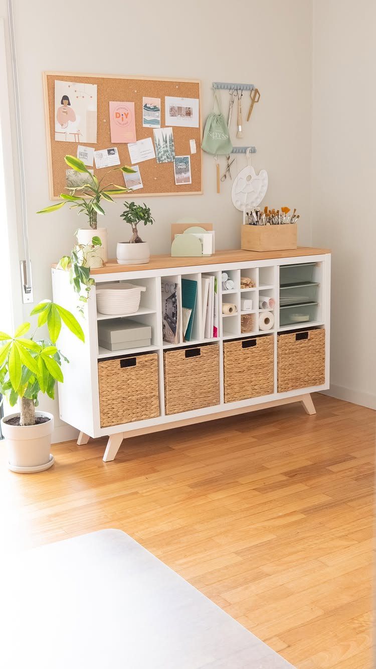 14 Office Decorating Ideas for Work to Refresh Your Space 14 White storage unit with woven baskets and a corkboard in a bright office