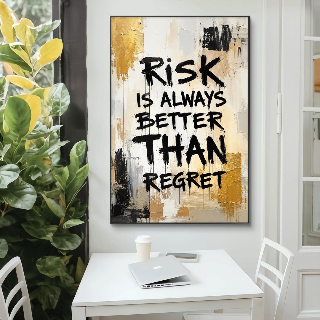 Motivational wall art with a quote hanging above a white home office desk.