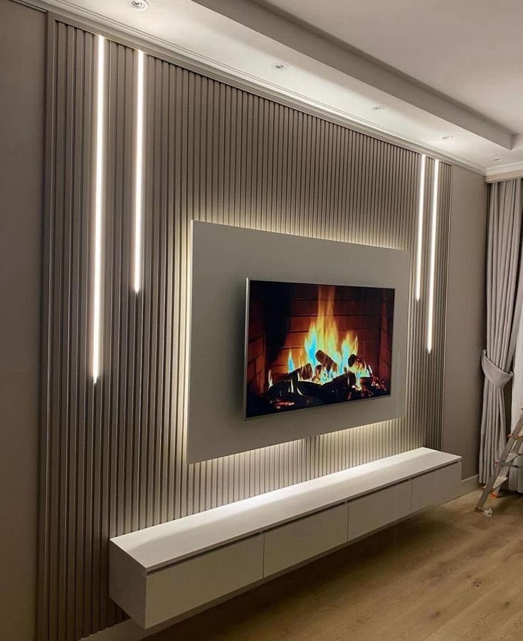 Backlit grey panel with a mounted TV against a ribbed wooden wall.