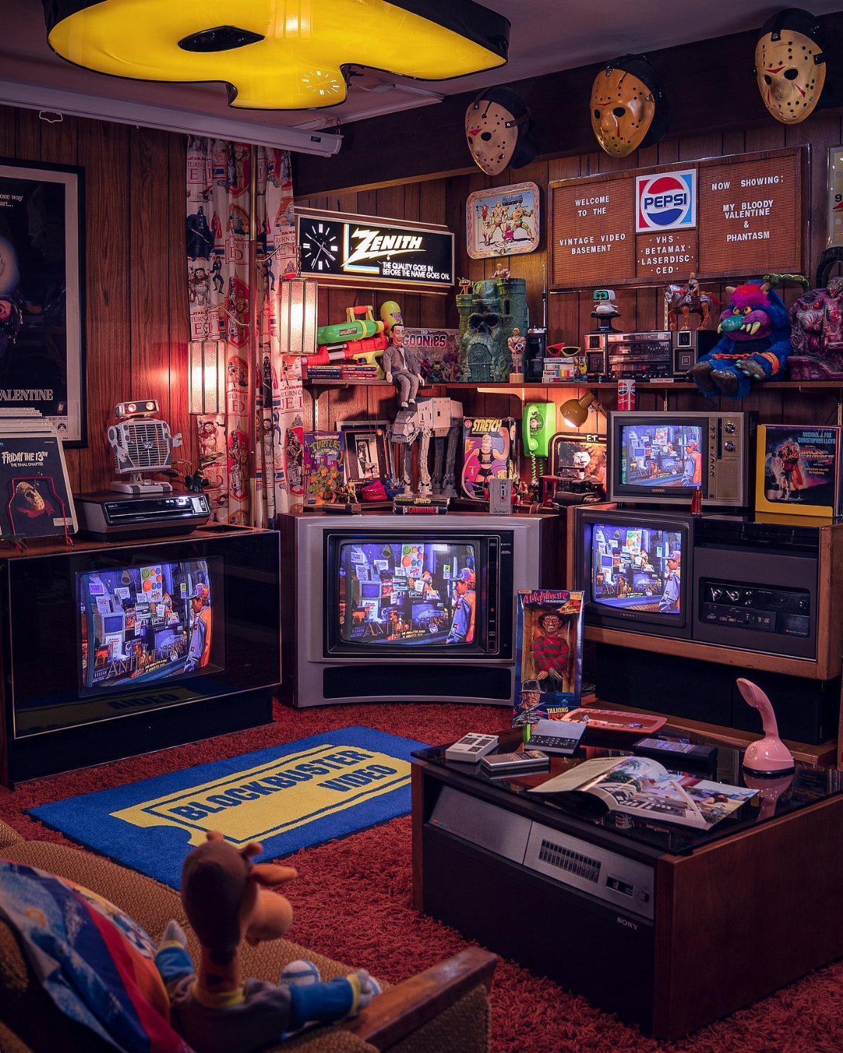 Retro gaming room with multiple CRT televisions, vintage consoles, and horror movie memorabilia.