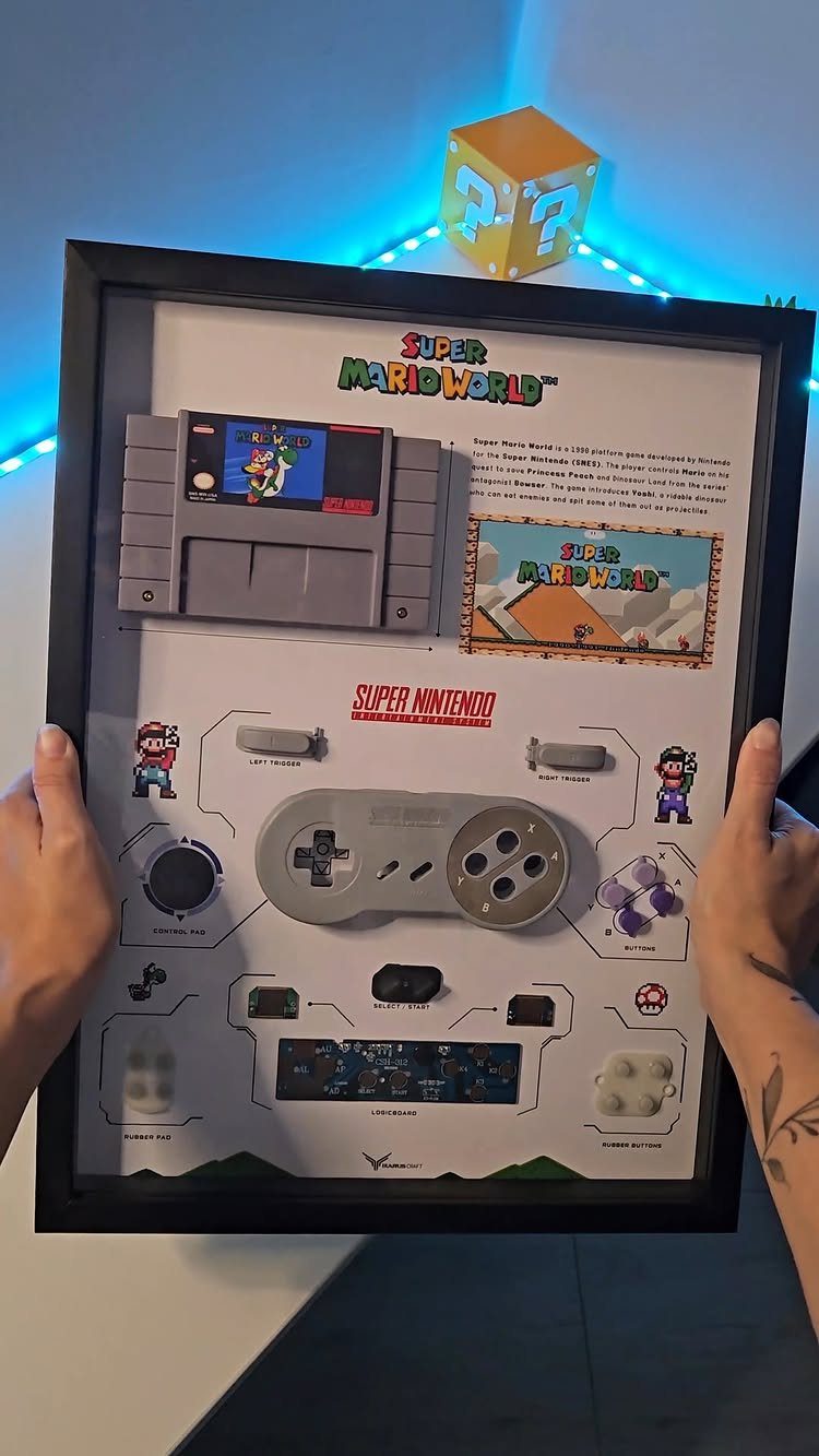 Framed shadow box display of a disassembled Super Nintendo and Super Mario World cartridge.