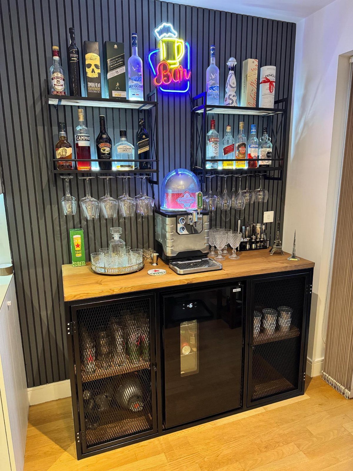 18 Small Bars for Home That Fit Any Space 4 Small black industrial home bar with wooden top and liquor bottles on shelves