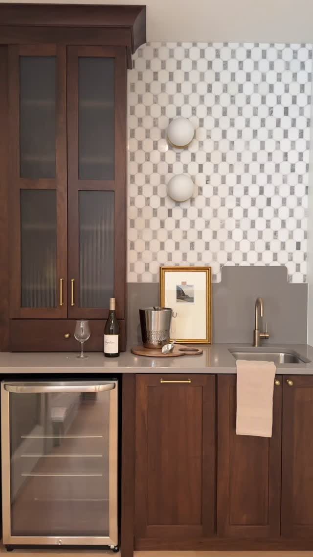 18 Small Bars for Home That Fit Any Space 16 Small home bar with dark wood cabinets, wine fridge, and patterned tile backsplash.