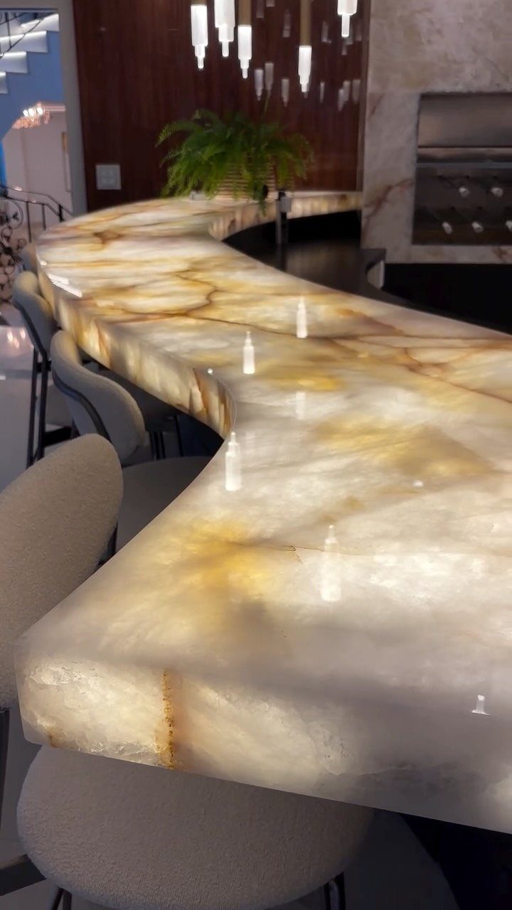 18 Small Bars for Home That Fit Any Space 12 Curved backlit onyx bar counter with glowing golden marble surface and white stools