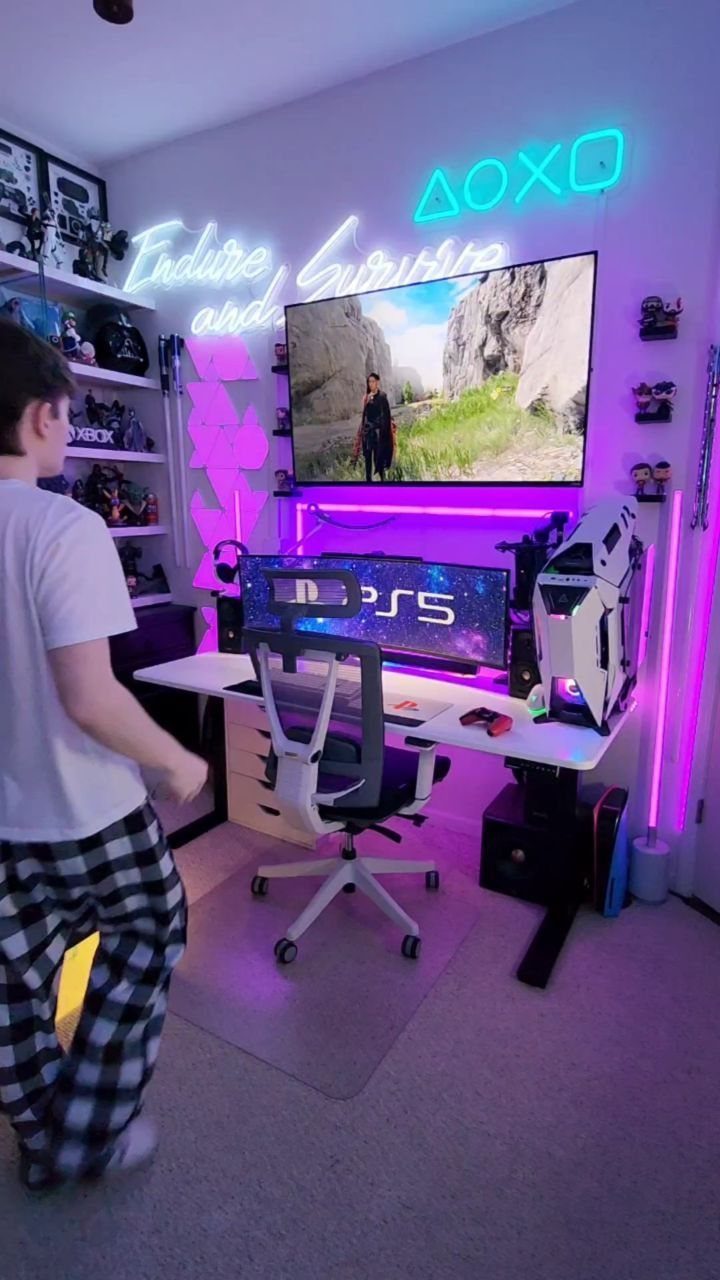 Wall-mounted TV and gaming setup with purple neon lights and a white desk.