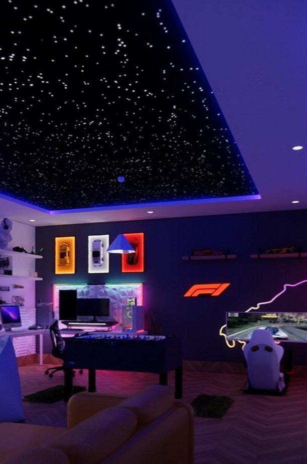 Gaming room with starry ceiling, blue LED lighting, and Formula 1 wall decor.