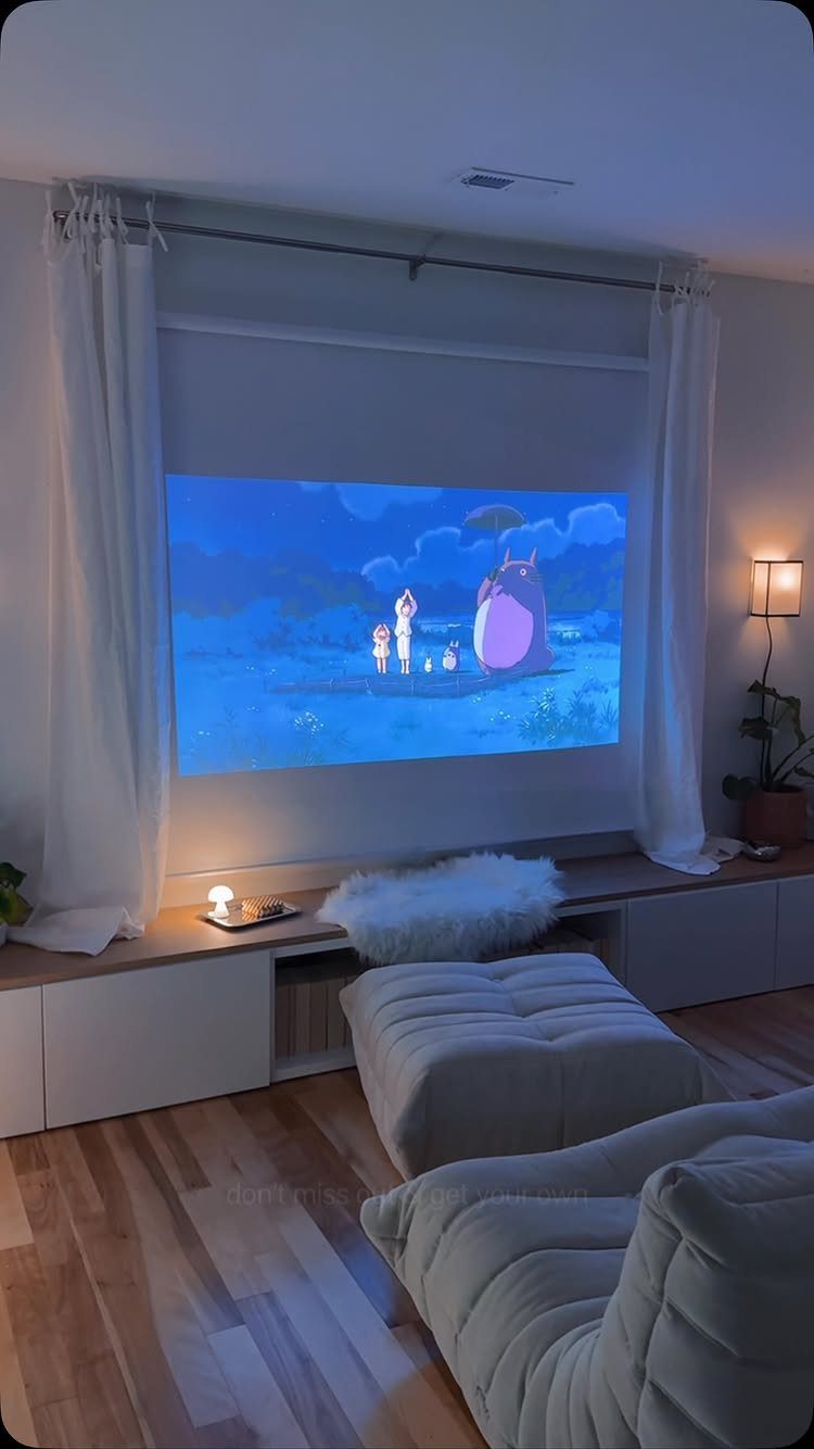 Projector screen showing animation in a cozy room with white lounge seating and curtains