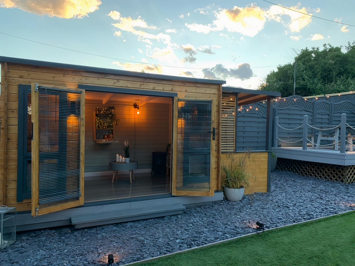 Modern wooden garden shed converted into a man cave with open folding doors.
