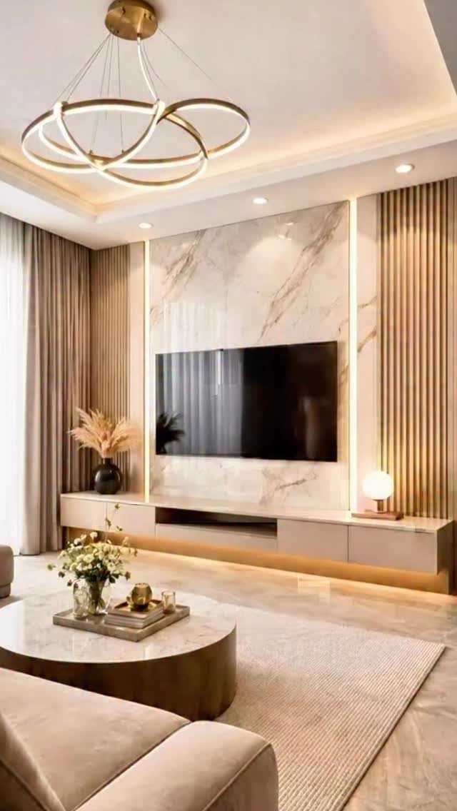 Modern living room with marble TV wall panel and low beige floating cabinet.